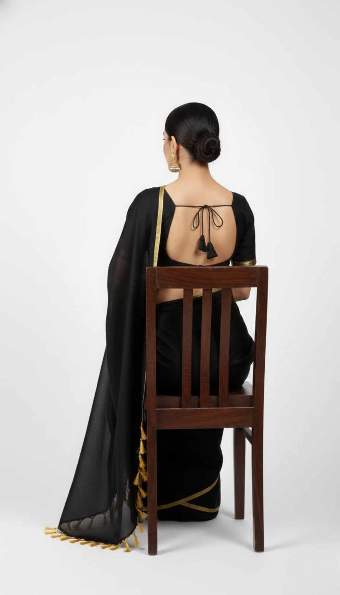 Black pure hand-woven khadi cotton saree with golden border and tassels