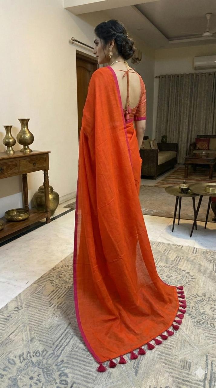 Orange pure hand-woven khadi cotton saree with pink selvage and tassels