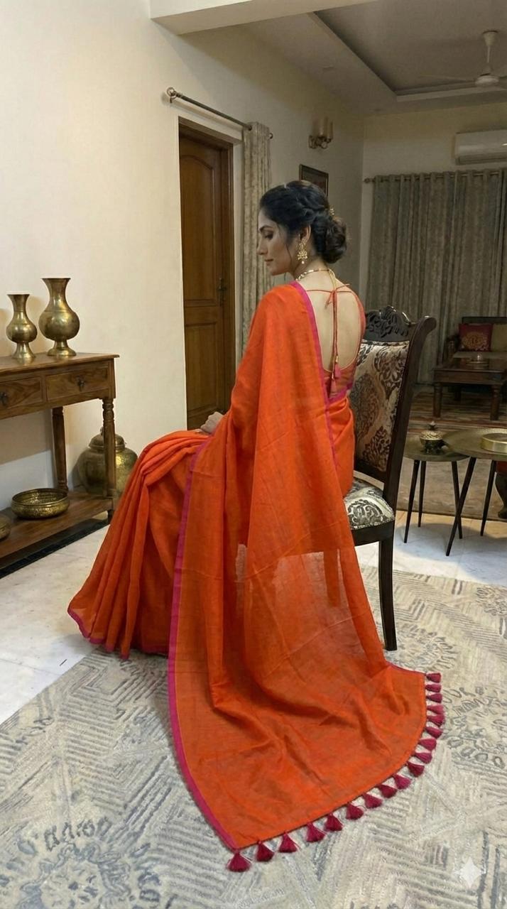 Orange pure hand-woven khadi cotton saree with pink selvage and tassels