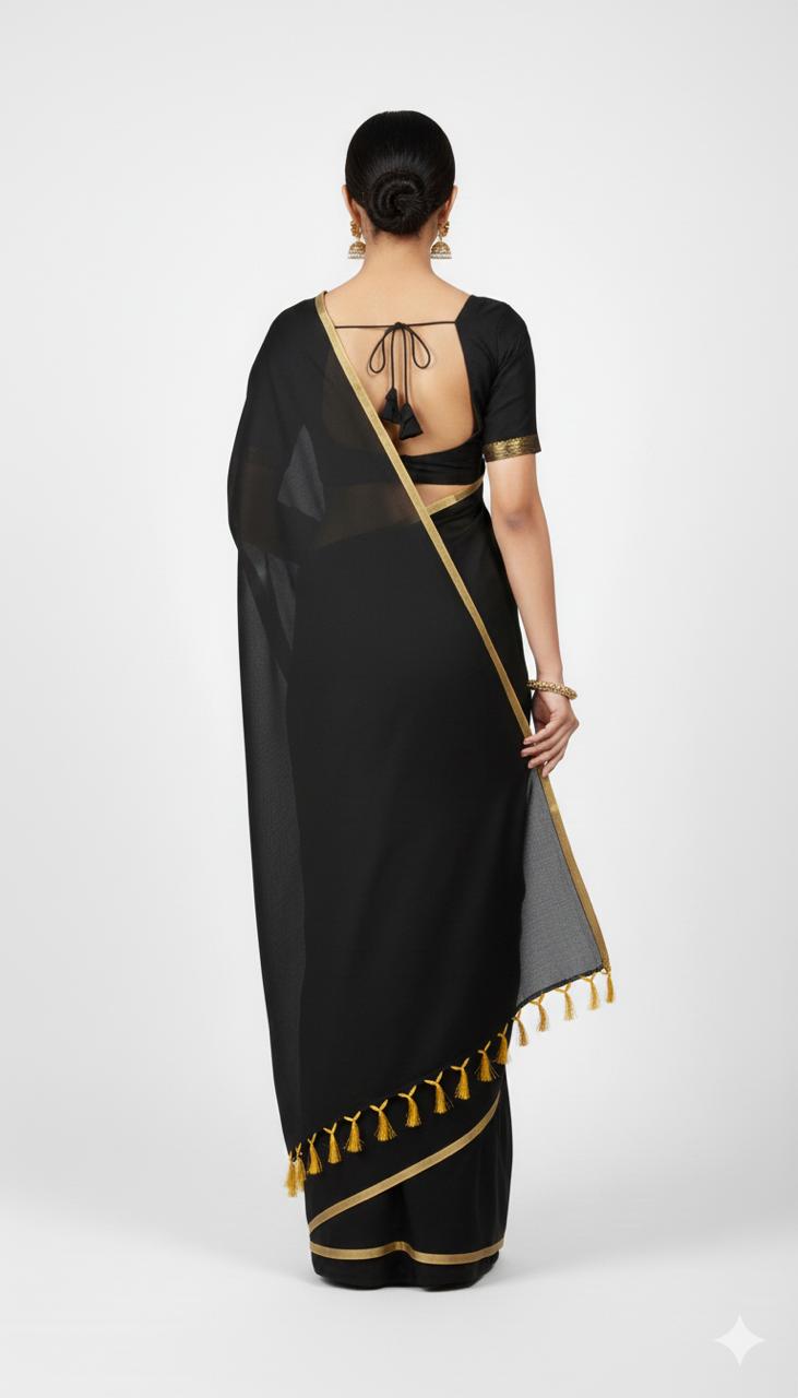 Black saree with gold border and tassels on a white background