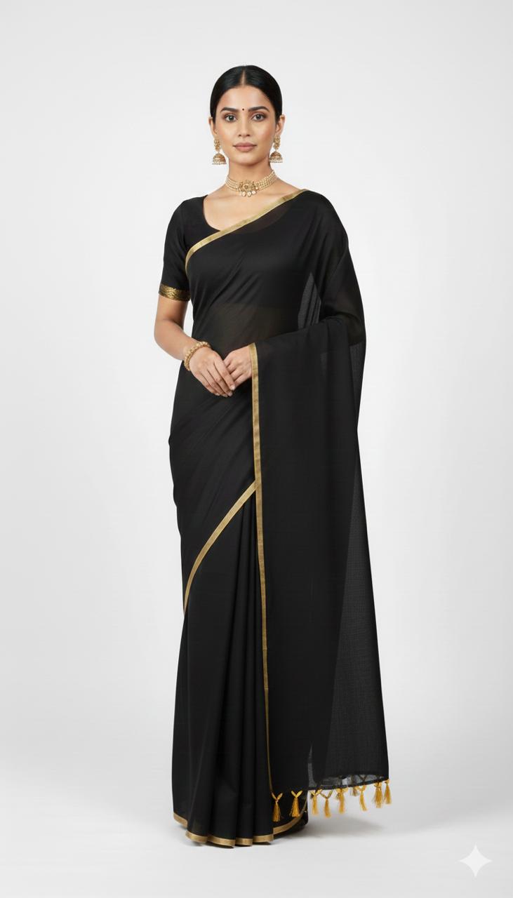 Woman wearing a black saree with gold trim on a white background
