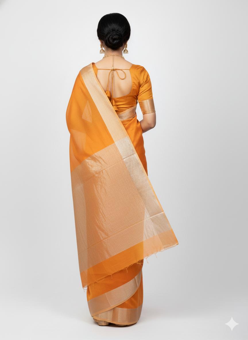 Woman wearing an orange saree with a white background