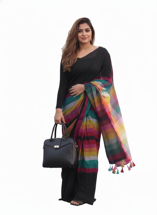 Woman holding a black handbag wearing a colorful scarf and black outfit on a white background